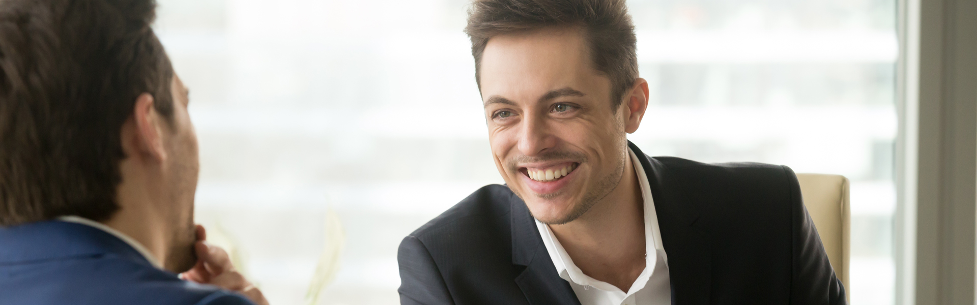 smiling young businessman with customer